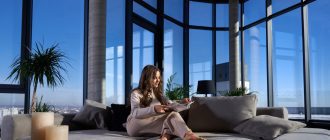 cute young woman reading book on sofa